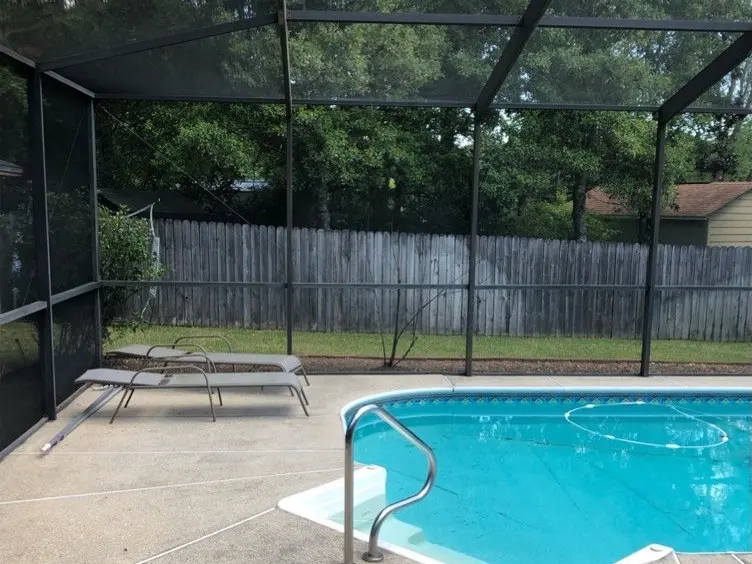 Screened pool enclosure and concrete deck